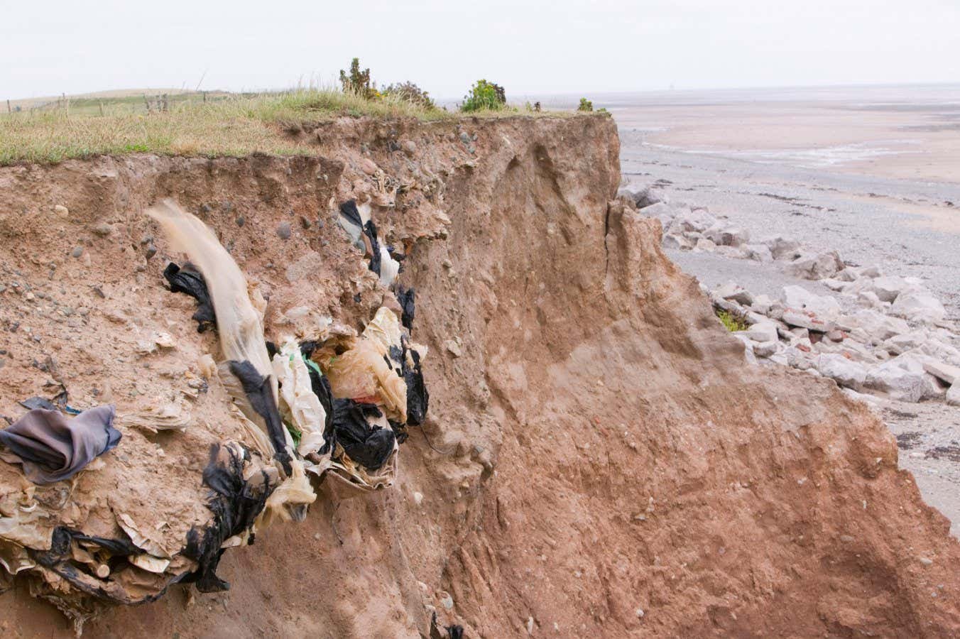 Toxic waste is spilling onto beaches as rising seas erode landfills